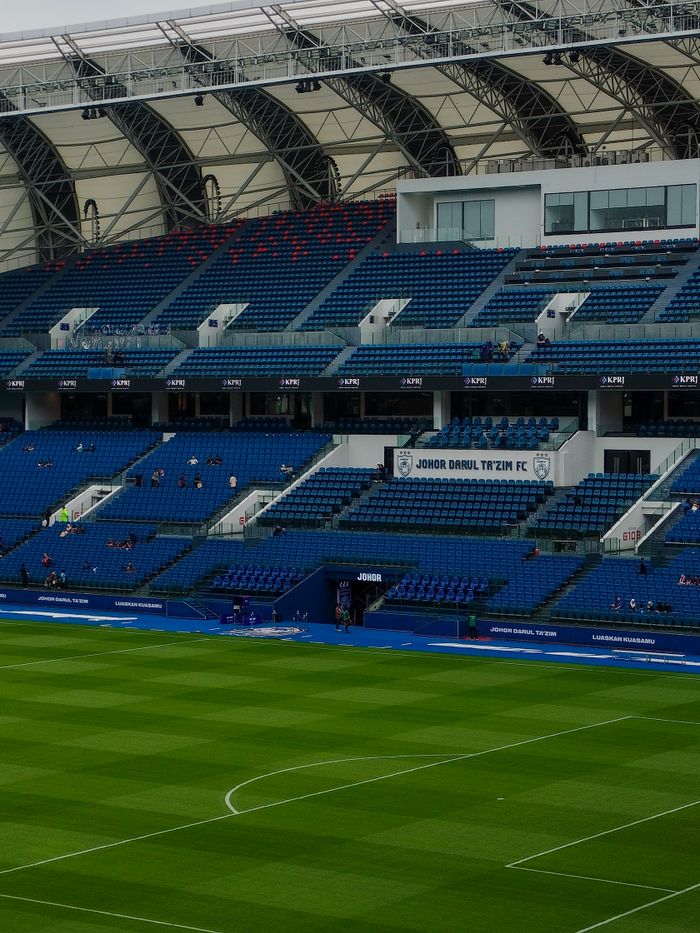 An empty football stadium showcasing the seating sections at Johor Darul Ta'zim FC in Malaysia.